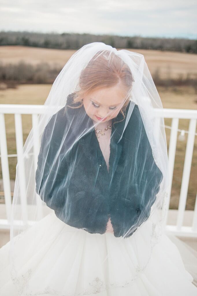 madeline stuart with black jacket over dress