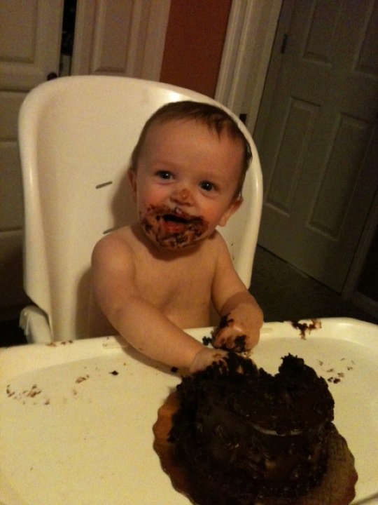 baby with cake on his face