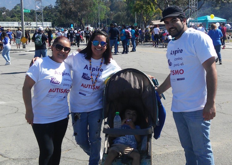 A family with two women a man and a child in a stroller at a marathon event