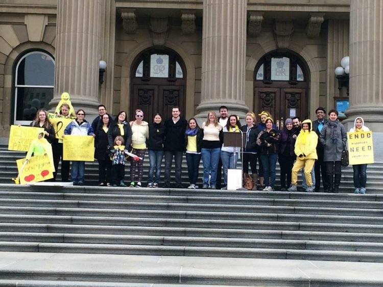 women lined up on steps of building with posters