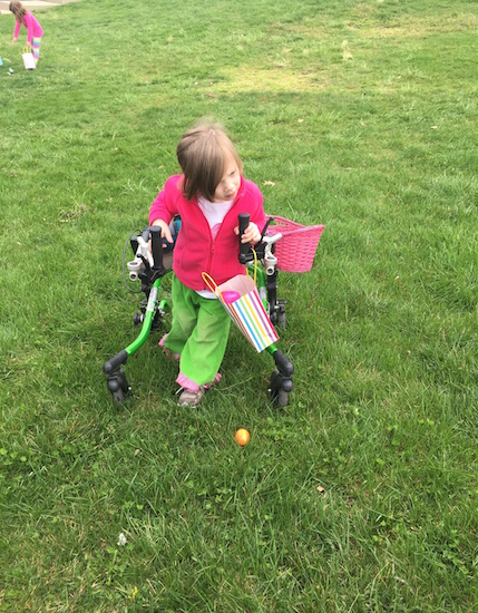 little girl on grass with walker