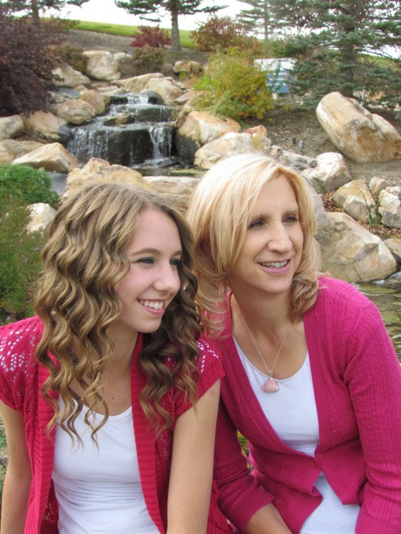 Claire and her mother in front of a waterfall