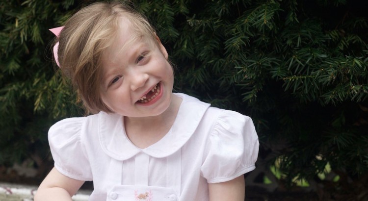 little girl in white dress smiling