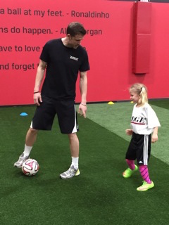little girl at soccer practice with her coach