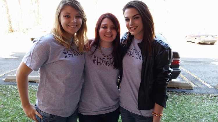 Skye, Lauren, and Christina standing next to each other with their #FDsister shirts