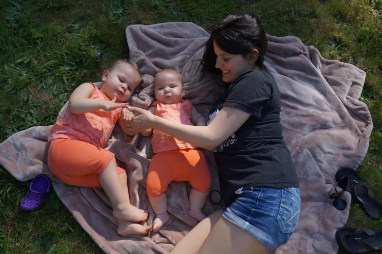 Author with her two daughters on a blanket outside