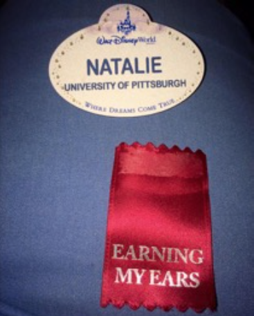 A close up of Natalie's name tag, and a ribbon that means "earning my ears"