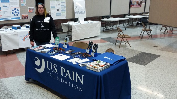 woman standing next to table for US Pain Foundation