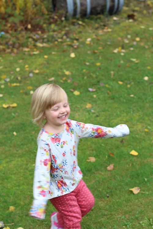Isla, little girl with blonde hair playing outside