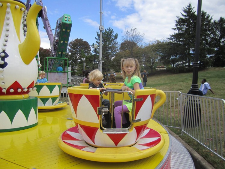Kathy's son and daughter riding tea cups at the fair