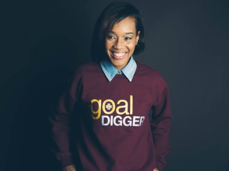 young woman wearing purple sweatshirt with words "goal digger" on it