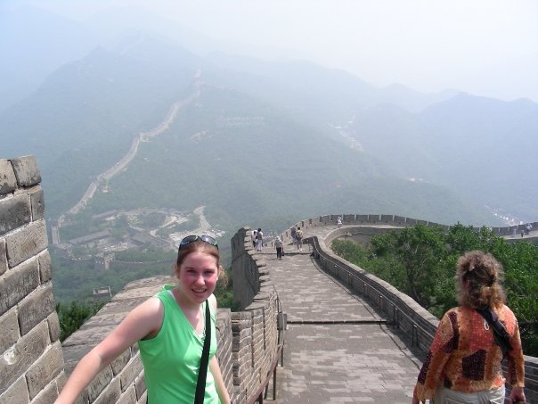 girl on the great wall of china wearing a green shirt