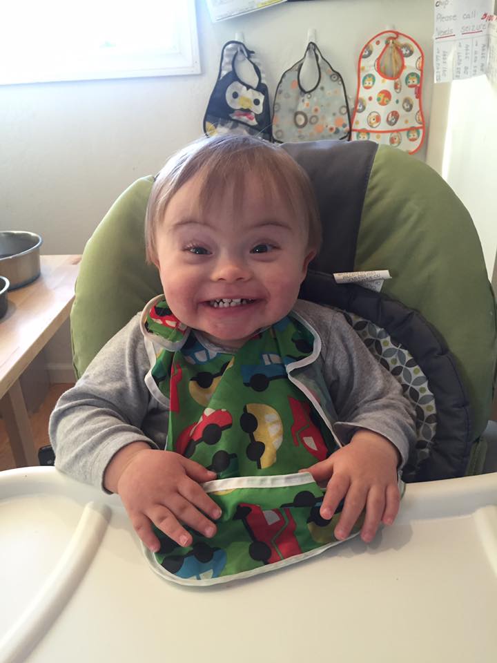 The author's son in a high chair, smiling