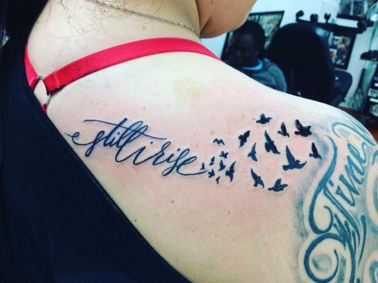 tattoo of birds and the words still i rise