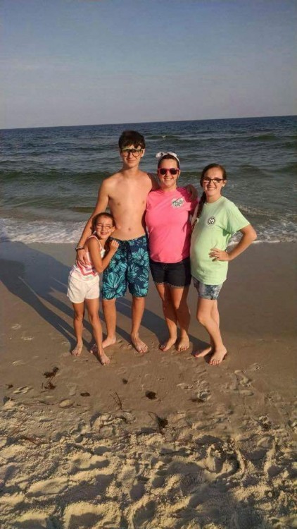 Mother and her three children at the beach. 