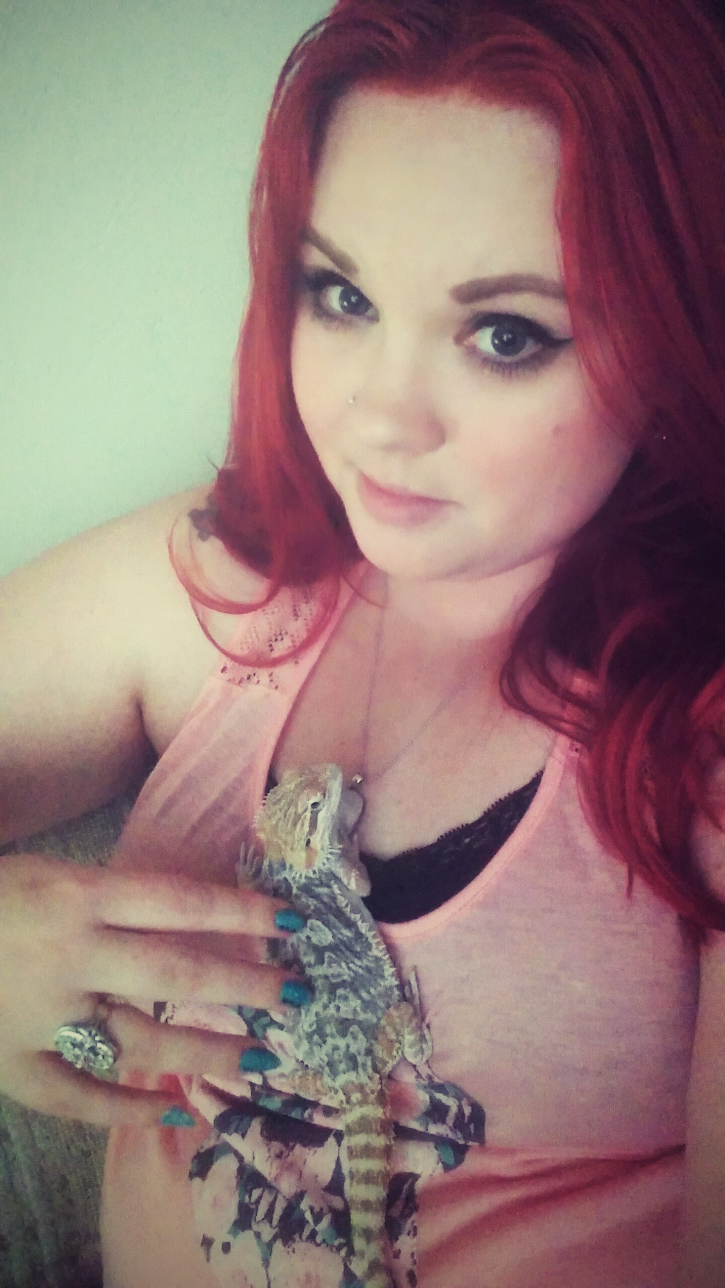 Woman holding her pet bearded dragon