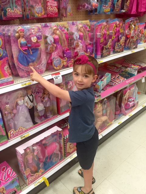 author's son picking out barbie doll