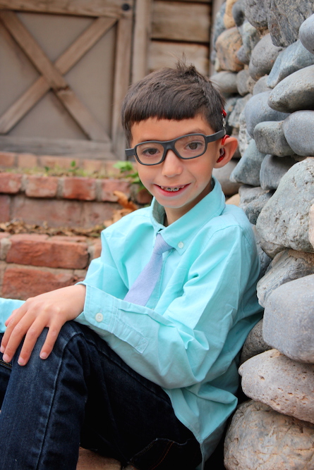 Joel in a shirt and tie smiling outside.