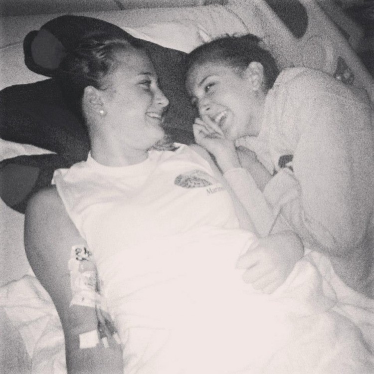 two women lying on a hospital bed in black and white photo