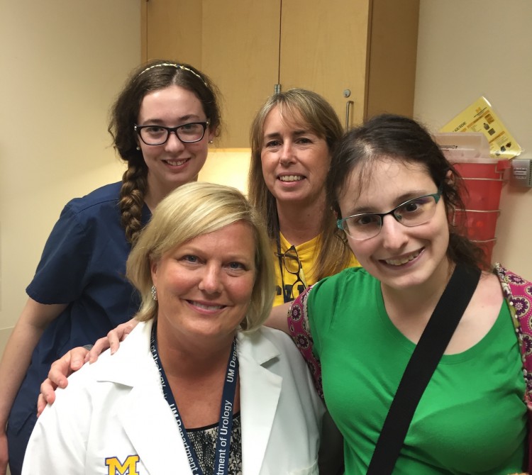 a woman with her doctor and two other members of her medical team