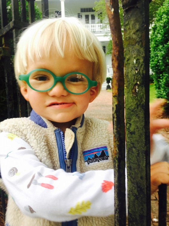 young boy wearing green glasses