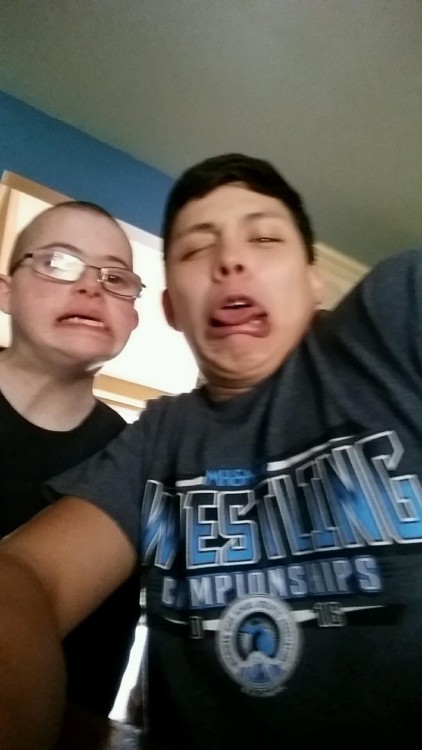 two young boys taking a funny selfie