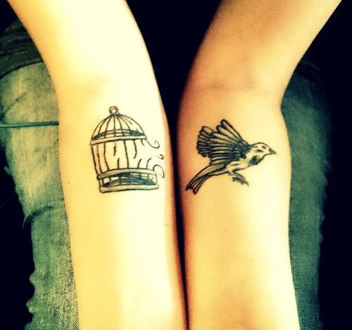 Tattoo of bird jumping out of its cage.
