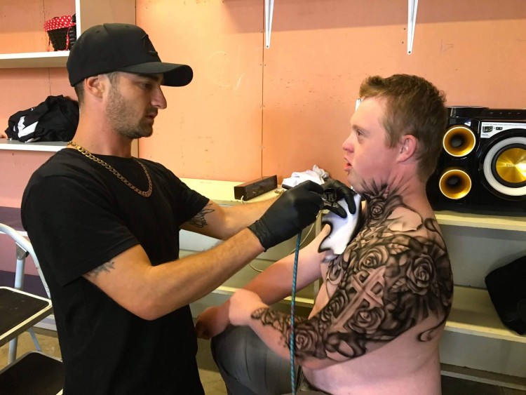 young man gets a tattoo