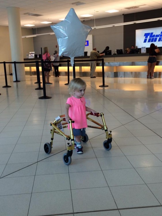 toddler using walker at airport