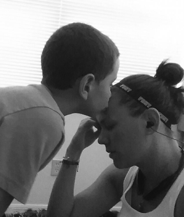 young boy kissing his mom's head