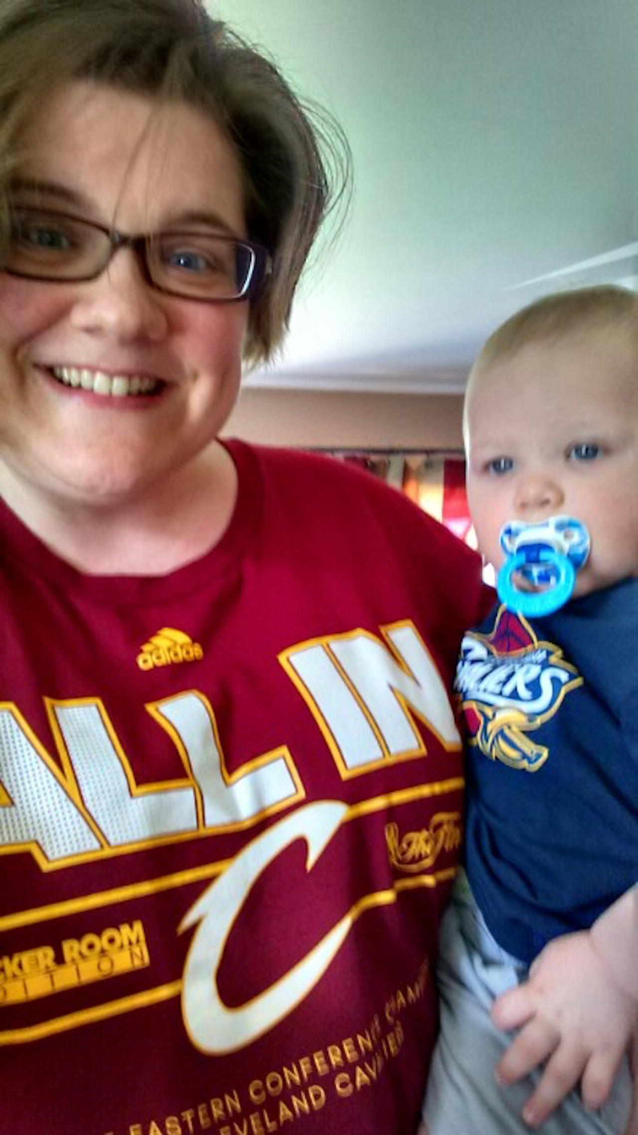 mom in cavs shirt holding baby in cavs shirt