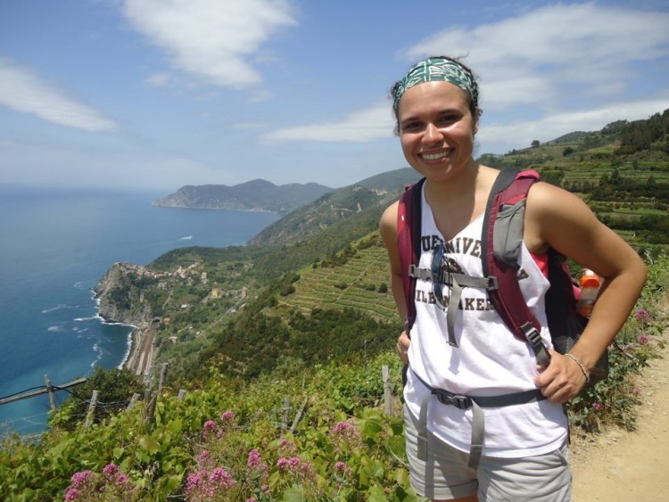 girl hiking in cinque terre with view of ocean