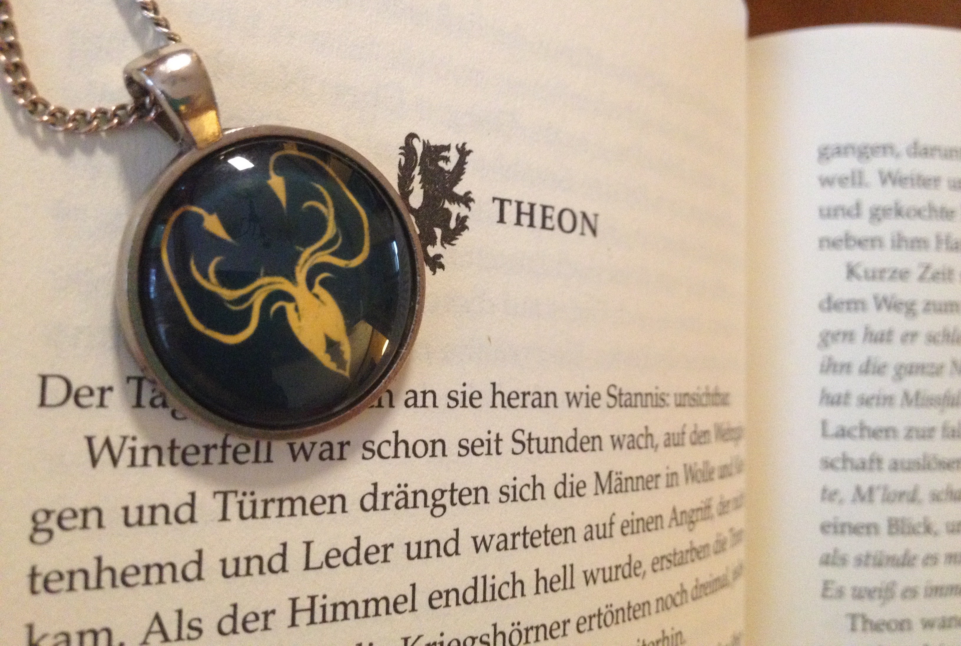 game of thrones book with locket over it