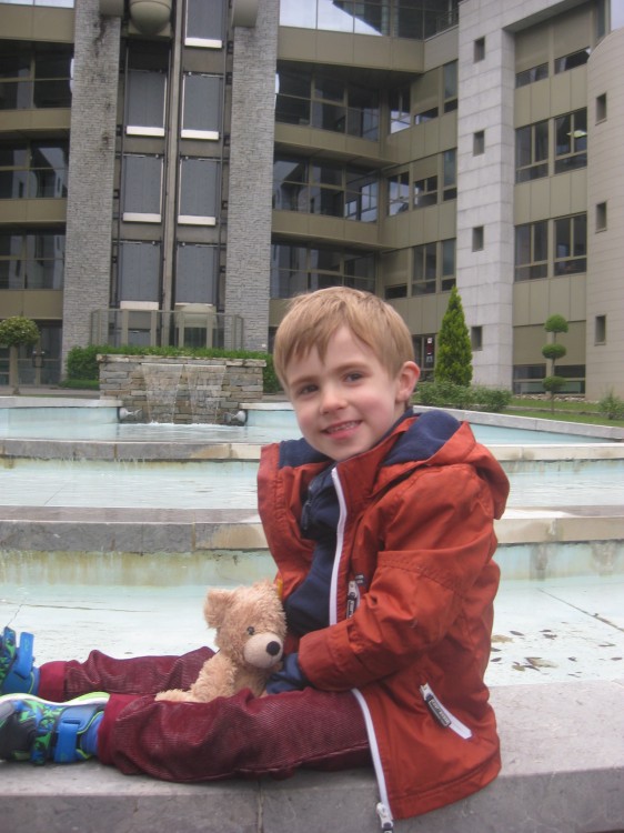 Luke smiling holding a teddy bear