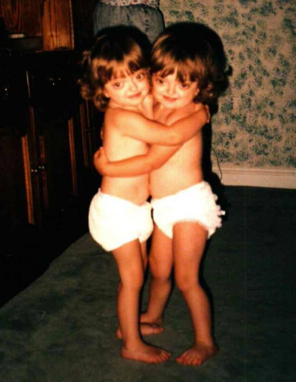 Ariel and her sister in diapers hugging