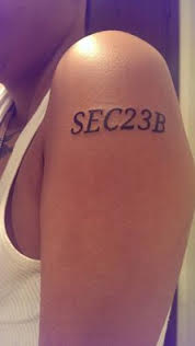 tattoo on jesse's arm reads "SEC23B"
