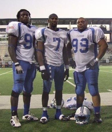 Nnaka and two of his teammates on the football field