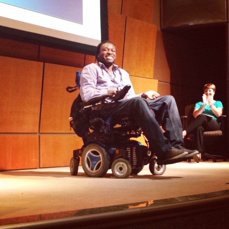 Nnaka giving a motivational speech while sitting in his wheelchair
