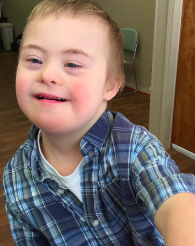 The author's son wearing a plaid button-down shirt