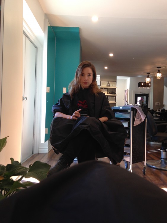 Woman sits in salon chair