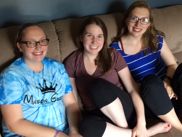 three women sitting on a couch together
