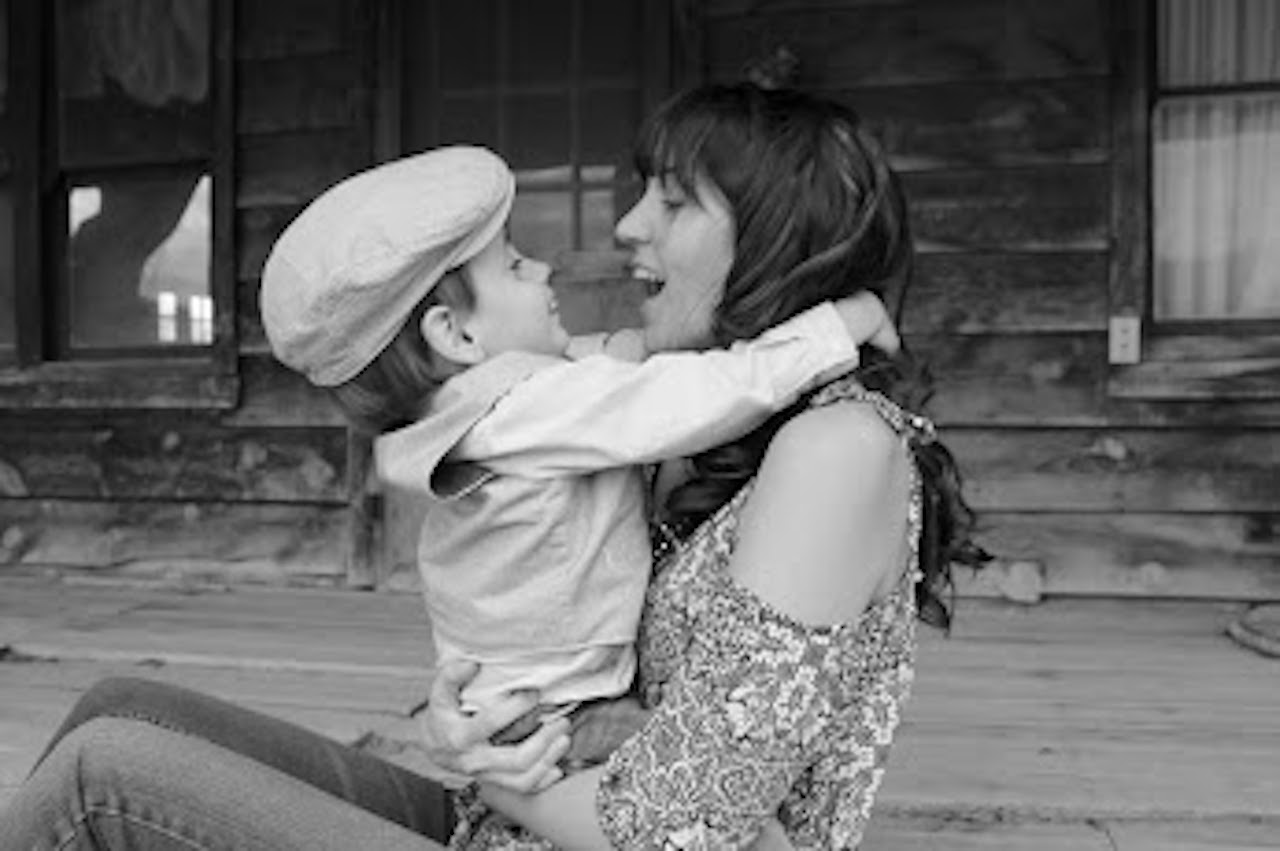 black and white photo of mom and son looking at each other