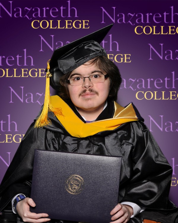Jonathan graduating from college with his degree in hand