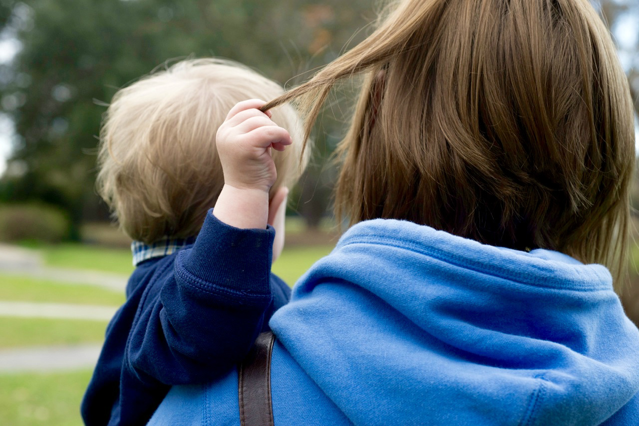 noah playing with his grandma's hair