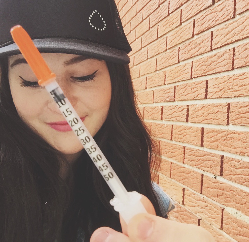 woman holding an insulin needle