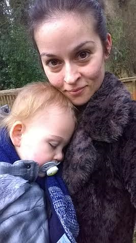 woman hugging toddler son who has head on her shoulder