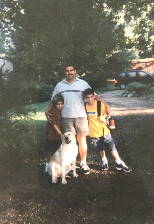 An old picture of the author, her father and her brother outside with their dog. 