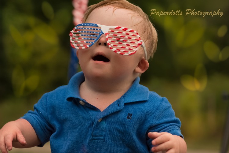 Young boy wearing patriotic sunglasses
