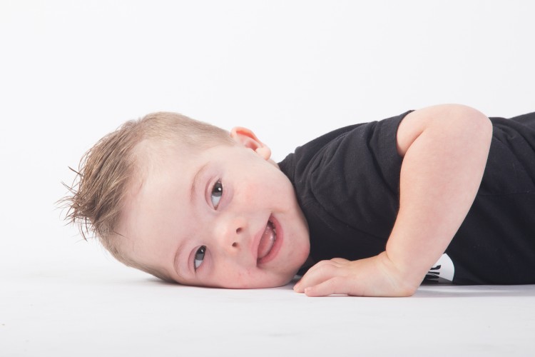 Little boy with Down syndrome modeling