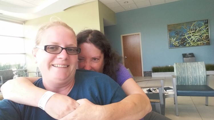 woman hugging her friend in selfie photo at hospital